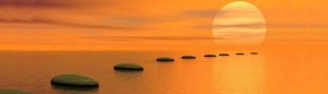 buddhist bloggers main image - sun rising over ocean with floating rocks
